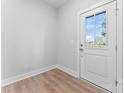 Bright entryway with wood flooring and a view of the exterior through a glass-paneled door at 722 Falling Oak Aly # 20, Huntersville, NC 28078