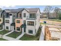 Townhome showcasing a modern exterior with brick accents, private balconies, and well-maintained landscaping at 722 Falling Oak Aly # 20, Huntersville, NC 28078
