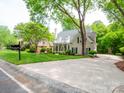 Beautiful home with a well-kept lawn, mature trees, and a spacious driveway at 7716 Seton House Ln, Charlotte, NC 28277