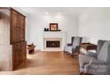 Cozy living room with fireplace, hardwood floors, and natural light at 7716 Seton House Ln, Charlotte, NC 28277