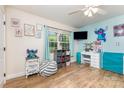Bright bedroom featuring hardwood floors, a window, a vanity, and creative decor at 878 Cold Springs Rd, Concord, NC 28025