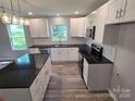 Updated kitchen boasts black countertops, subway tile, stainless appliances and ample cabinet space at 901 3Rd St, Spencer, NC 28159