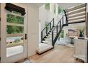 Bright foyer featuring a modern staircase, hardwood flooring, and high ceilings at 9305 Valley Rd, Charlotte, NC 28270