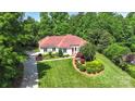 Beautiful one story home featuring well-manicured lawn, landscaping, and long driveway at 1004 Berwick Ct, Waxhaw, NC 28173