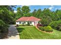 Charming one story home with lush lawn and well-maintained landscape at 1004 Berwick Ct, Waxhaw, NC 28173