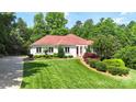 Charming home with well-manicured lawn, red roof, and a basketball hoop at 1004 Berwick Ct, Waxhaw, NC 28173