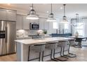 Modern kitchen features a large island with white countertops and stainless steel appliances at 12017 Grinstead Ln # 301, Charlotte, NC 28278