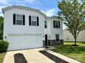 Charming two-story home boasts a two-car garage, black shutters and stone accents at 12713 Frank Wiley Ln, Charlotte, NC 28278