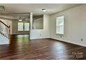 Bright living room featuring hardwood floors, neutral paint, and large windows at 12713 Frank Wiley Ln, Charlotte, NC 28278