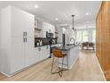 Modern kitchen with white cabinets, dark countertops, and stainless steel appliances at 1354 Briar Creek Rd, Charlotte, NC 28205