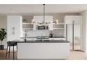 Bright, modern kitchen with white cabinetry, stainless steel appliances, and a large island with seating at 1354 Briar Creek Rd, Charlotte, NC 28205
