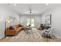 Bright living room featuring a leather sectional, modern decor, and French doors to the backyard at 1354 Briar Creek Rd, Charlotte, NC 28205