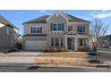 Charming two-story brick home with a well-manicured lawn, attached garage, and inviting front entrance at 14004 Fiery Mist Way, Huntersville, NC 28078