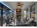 Covered patio with a stone fireplace, comfortable seating, and an outdoor living space at 14004 Fiery Mist Way, Huntersville, NC 28078