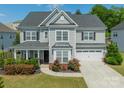 Charming two-story home features a manicured lawn and an attached two-car garage at 2164 Hanging Rock Rd, Fort Mill, SC 29715