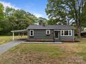 Single story home with a covered carport, tidy landscaping, and neutral color scheme at 322 Corriher Heights Ave, China Grove, NC 28023