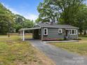 Single story home with a long covered carport and tidy landscaping at 322 Corriher Heights Ave, China Grove, NC 28023