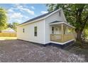 Side view of a light-colored home showcasing its clean lines and well-maintained gravel surrounding the property at 555 Pryor St, Chester, SC 29706