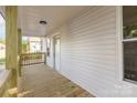 Inviting front porch featuring wood flooring, light walls, and a view of the entry door and surrounding neighborhood at 555 Pryor St, Chester, SC 29706