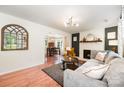 Open-concept living room showcasing hardwood floors, fireplace, and a seamless flow into the dining area at 604 Chaney Rd, Monroe, NC 28110