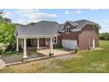 Charming brick home with a covered carport and a two-car garage at 6218 Indian Trail Fairview Rd, Indian Trail, NC 28079