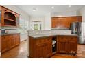 Kitchen with custom wood cabinets, gray countertop, and stainless steel appliances at 6218 Indian Trail Fairview Rd, Indian Trail, NC 28079