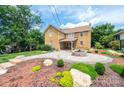 Backyard with circular brick patio, manicured landscaping, and inviting fire pit feature at 625 2Nd Ne St, Hickory, NC 28601