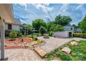 Expansive backyard with brick patio, fire pit, storage shed, and lush landscaping at 625 2Nd Ne St, Hickory, NC 28601