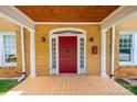 Covered front porch featuring a red door, white columns, and tiled flooring at 625 2Nd Ne St, Hickory, NC 28601