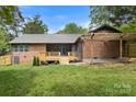 Expansive backyard with a wooden deck, and brick patio, perfect for outdoor entertaining and relaxation at 7221 Leaves Ln, Charlotte, NC 28213