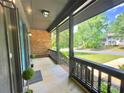 Inviting covered porch with gray railing and ample space, overlooking a well-maintained lawn at 7221 Leaves Ln, Charlotte, NC 28213
