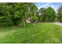 Lush front yard showcasing a well-maintained lawn and mature trees, creating a serene setting at 7525 Windy Pine Cir, Denver, NC 28037