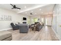 Spacious living room featuring modern flooring, a fireplace, and ample natural light at 7525 Windy Pine Cir, Denver, NC 28037