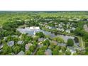 Serene aerial view of a lakeside community, highlighting lush greenery and well-maintained homes near the water at 7811 Compton Ct, Charlotte, NC 28270