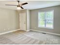 Bedroom features neutral walls, carpet, a ceiling fan, and a window at 915 Klondale Ave, Kannapolis, NC 28081