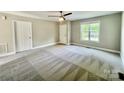 Neutral bedroom features carpet, ceiling fan, and window letting in natural light at 915 Klondale Ave, Kannapolis, NC 28081