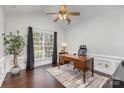 Bright office with a large window, hardwood floors, wainscoting and a wooden desk at 10202 Alouette Dr, Waxhaw, NC 28173