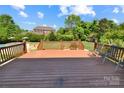 Spacious wooden deck overlooking the backyard with green grass and lush foliage at 11917 Chevis Ct, Charlotte, NC 28277