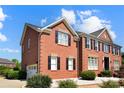 Classic brick home with black shutters and a two-car side entry garage at 11917 Chevis Ct, Charlotte, NC 28277