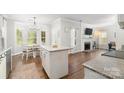 Bright kitchen island overlooking breakfast nook and living room with fireplace at 12328 Chickasaw Dr, Huntersville, NC 28078