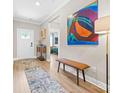 Bright entryway featuring wood floors, neutral walls, artwork, and bench at 12705 Twilight Dr, Mint Hill, NC 28227