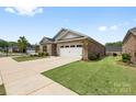 All brick home with 2 car garage, trimmed lawn, and mature landscaping at 12705 Twilight Dr, Mint Hill, NC 28227