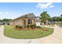 Charming brick home with fresh landscaping, including mulch, greenery and trees in a well maintained lawn at 12705 Twilight Dr, Mint Hill, NC 28227