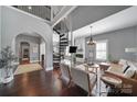 Spacious living room features a spiral staircase, hardwood floors, and a cozy fireplace at 1517 Parkwood Ave, Charlotte, NC 28205
