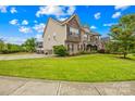 Spacious home boasts a large, landscaped yard, driveway and a mix of stone and traditional siding at 15702 Guthrie Dr, Huntersville, NC 28078