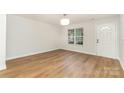 Bright, airy living room with hardwood floors and a large window providing natural light at 1620 Crandon Dr, Charlotte, NC 28216