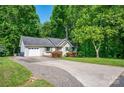 Single Gathering house with a paved driveway and lush landscaping at 177 Candlestick Dr, Statesville, NC 28625