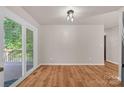 Bright living area features wood-look flooring, a sliding glass door, and neutral walls at 177 Candlestick Dr, Statesville, NC 28625