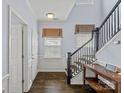 Elegant foyer features hardwood floors, a staircase with dark wood banister, and light-blue walls at 1948 Winpole Ln, Charlotte, NC 28273