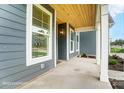 Inviting front porch with wood plank ceiling and views of the neighborhood at 2028 Cedar Falls Dr # 10, Waxhaw, NC 28173
